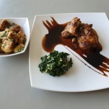 Chicken Thighs in Balsamic Glaze served on a buttered bed of Spinach with gnocci in brown butter sauce.